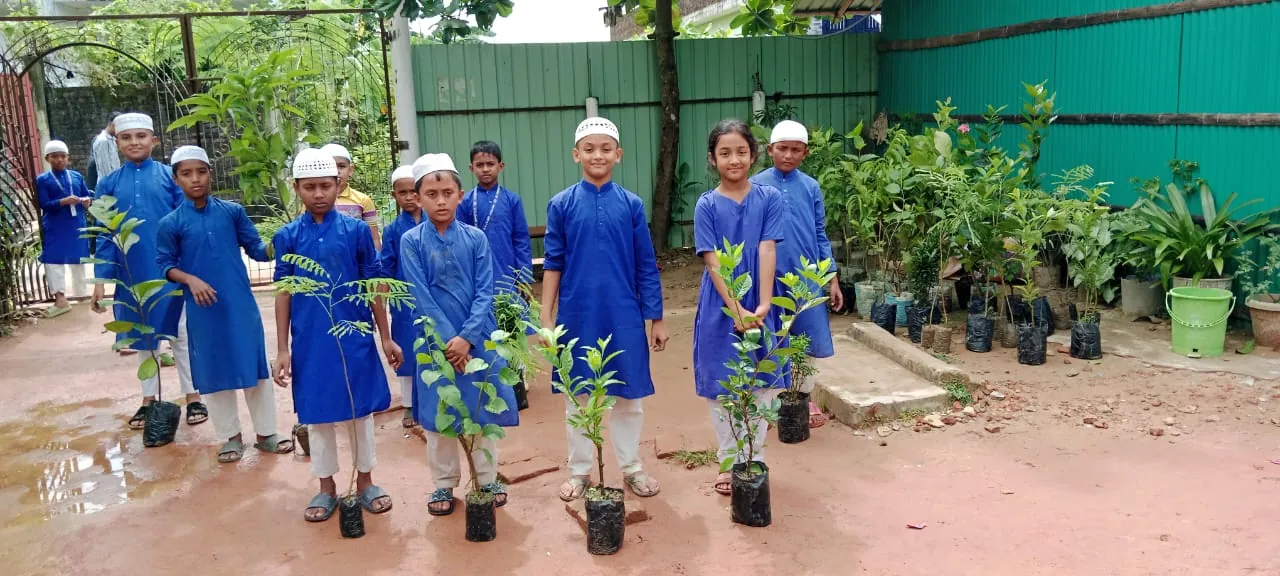 Children at an orphanage hold saplings funded by Ruhama
